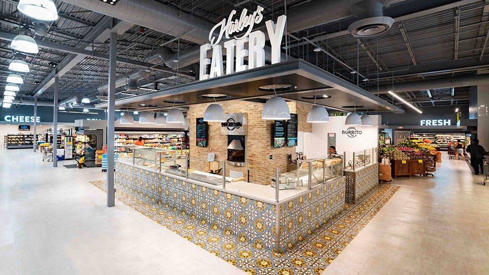 The heart of the store is the eye catching “Hurley’s Eatery” with made-to-order international food fare. A perforated metal canopy and decorative tiles highlight this service point.