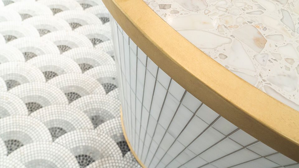 Materials like grasscloth, raw oak, brass and stone have been used to give a sense of natural craft, quality and authenticity while always making the product the vibrant hero.