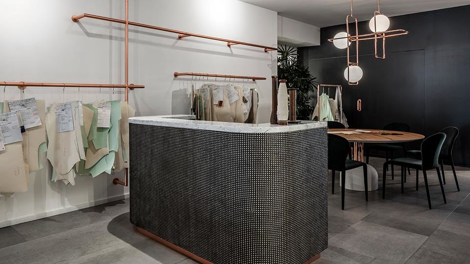 The space serves as both a customer storefront for tailoring and small brands, with an in-house seamstress in the back.