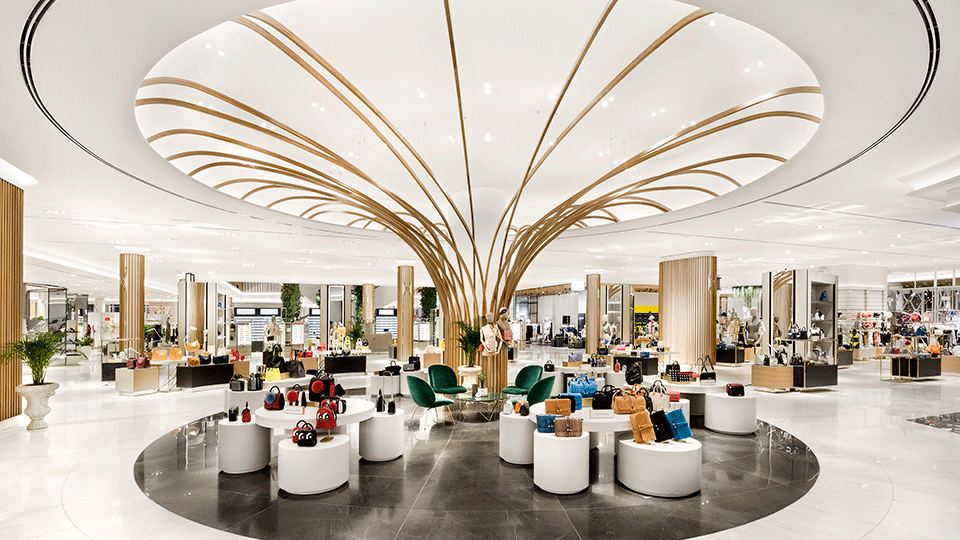 The first floor is dedicated to womenswear and accessories, and is articulated by a series of internal rotundas, each of which are centered on a swooping, tree-like timber frame, designed to filter daylight and create memorable sculptural statements.