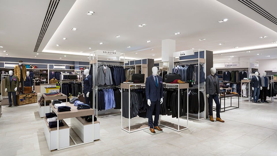 In the menswear zone, sleek white metal outlines come wrapped in grey-washed timber, creating a series of open rooms for brands to inhabit.