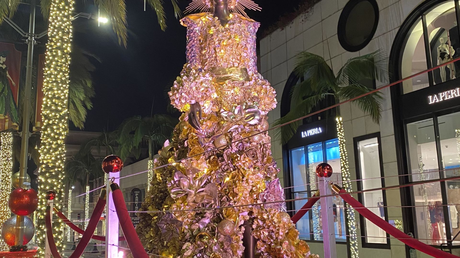 The runway mannequins were dressed in “Holiday Glamour”-inspired looks of jeweled-toned florals, winter foliage and reflective embellished accents of metallic ball ornaments.