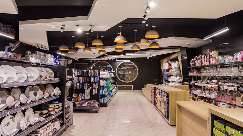 The design of the store features a bold ceiling with varying levels and textures.