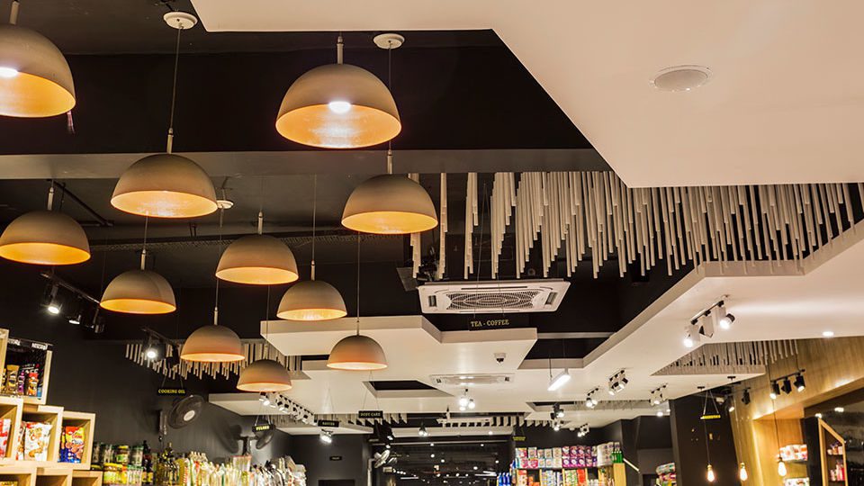The variety of ceiling textures break up the conventional movement pattern created by the placement of racks in the store.