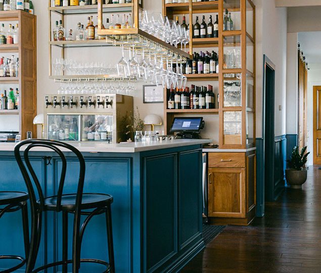 The owners and design team wanted Nouvelle to feel like a Parisian wine bar—modern, but French and masculine and feminine at the same time. The blue was inspired by a front door on a building in Paris, something carried out through the entire space.