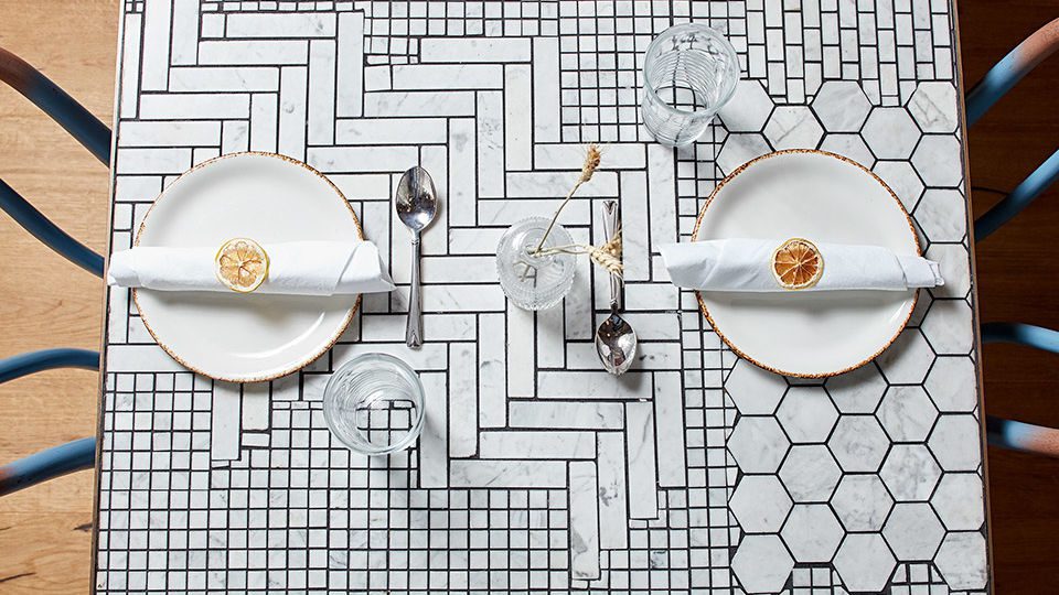 Whimsical painted bentwood seating dresses the main dining space, and the custom marble mosaic tabletops have an artisan quality–the perfect backdrop for that Instagram shot.