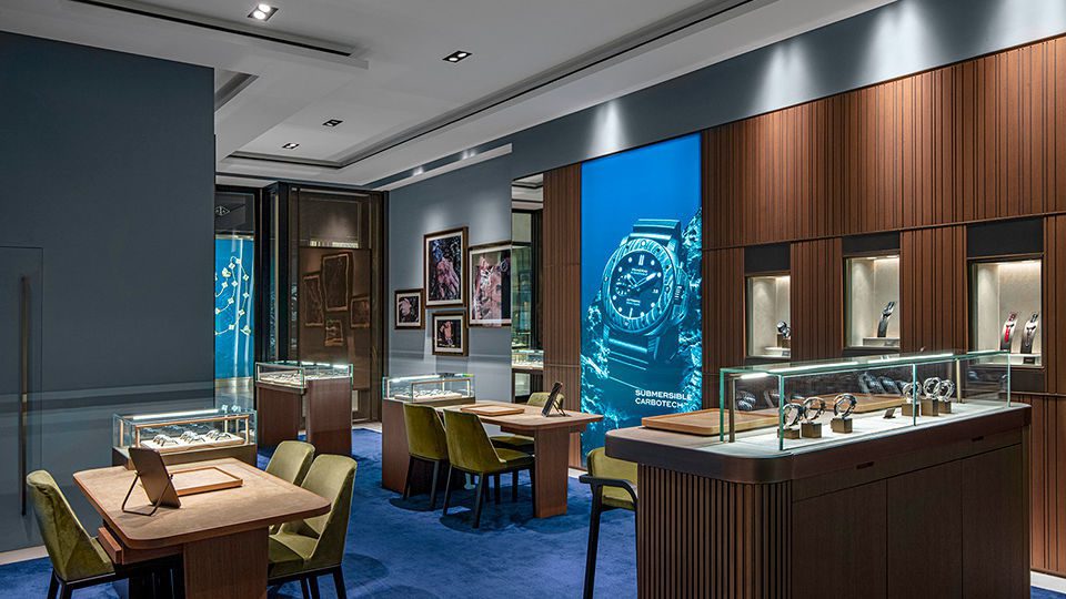 The store exudes a prominent masculine energy, evident in the choice of dark paneling and cool tones throughout the space.