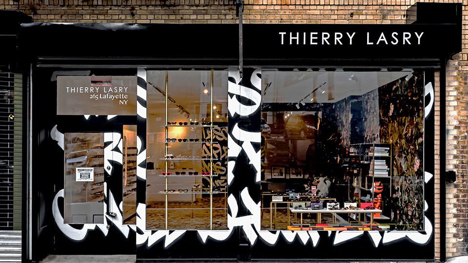 French luxury eyewear brand Thierry Lasry opens its doors in the Soho district of Manhattan, marking the brand’s first stand-alone boutique in New York. The façade of the retail space is covered in graffiti by New York-based artist Faust, which also covers the interior walls of the store.