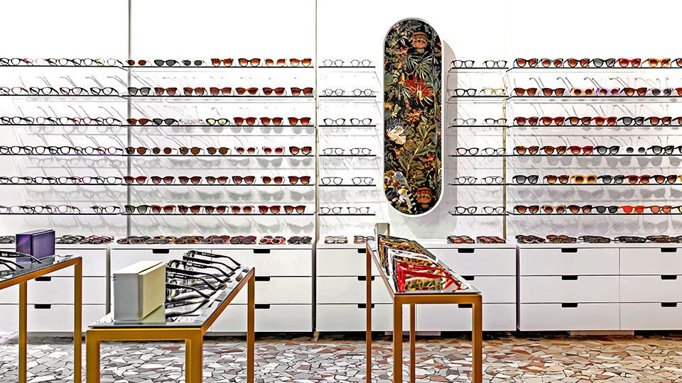 The focal point of the boutique remains the eyewear, displayed in a minimal setting on one side of the space with jungle-themed designs covering the opposite side