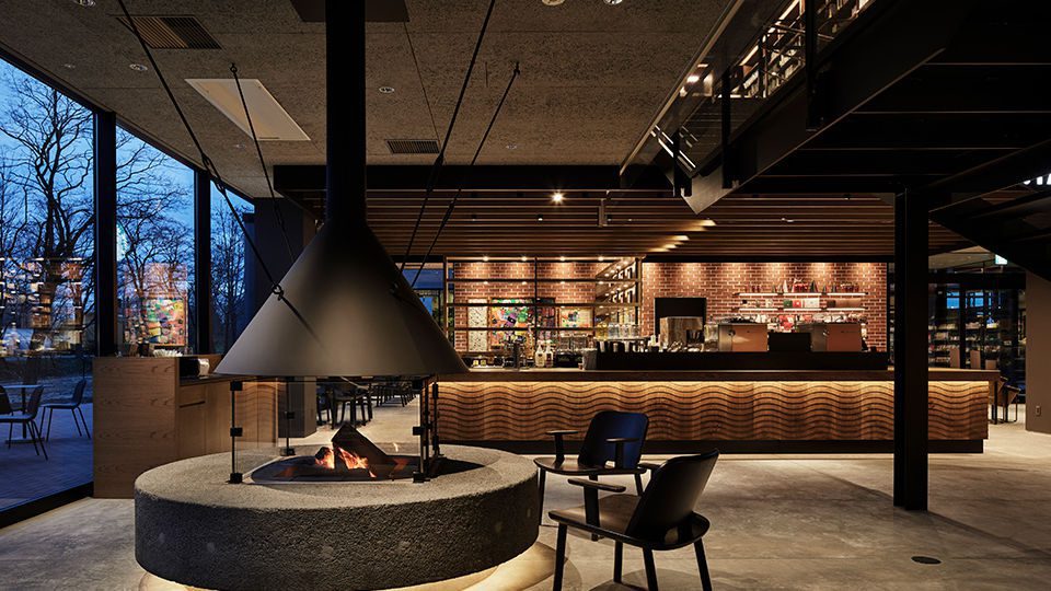 The three blocks are assigned the respective themes of Mind, Life, and Food, and the interiors are configured to offer framed views of the forest as well as a sense of unity.