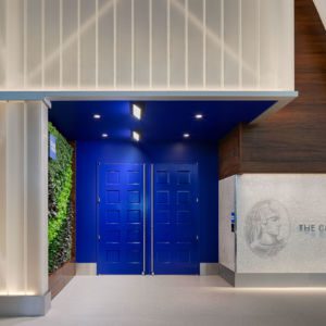The new lounge experience features bold blue doors and a branded façade mosaic wall that was inspired by NYC subway murals.