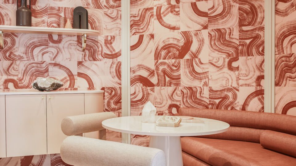 The interior reflects the brand's color palette and hues of pinks, rusts and creams.