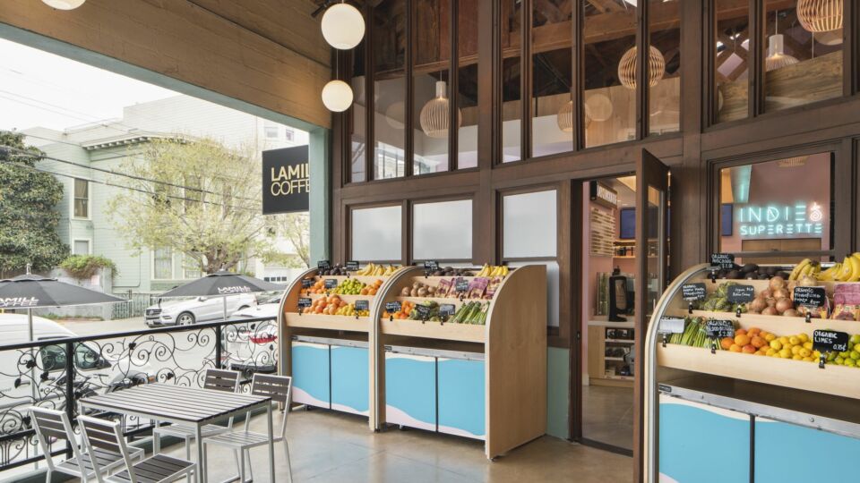 Upon entering Indie Superette, guests are welcomed into the market’s covered outdoor patio, which is raised from the street level and features fresh fruit stands as well as small tables for customers.