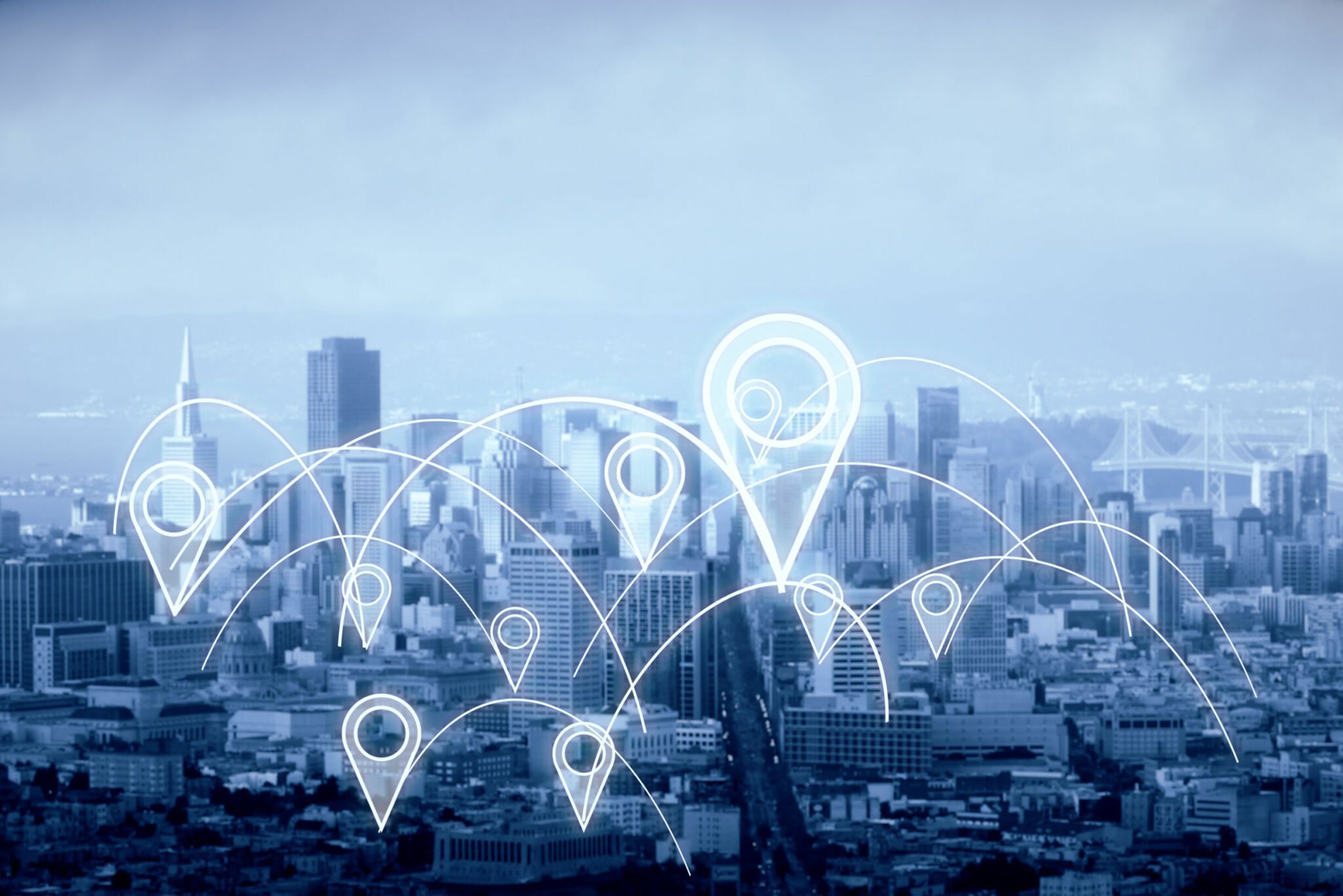 A cityscape with targeting pins scattered across it to illustrate localized marketing