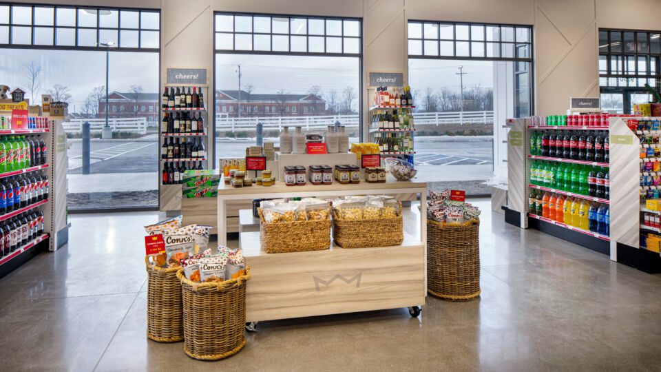 Oversized windows and columns merchandised with wine become a natural backdrop to the local flavors on display.