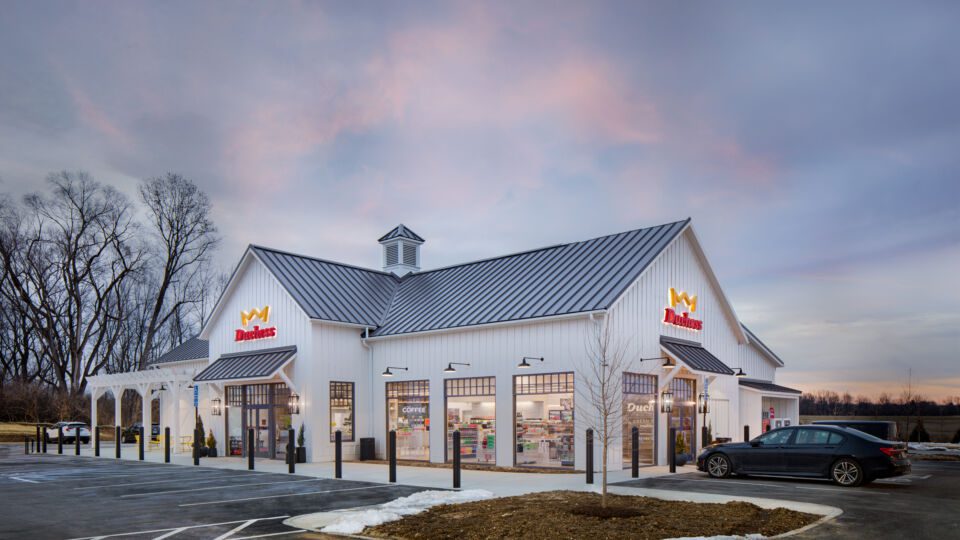 Two convenient entryways flanked by oversized lanterns draw customers into the store, while bright, warm lights and unique textures spill out from inside.