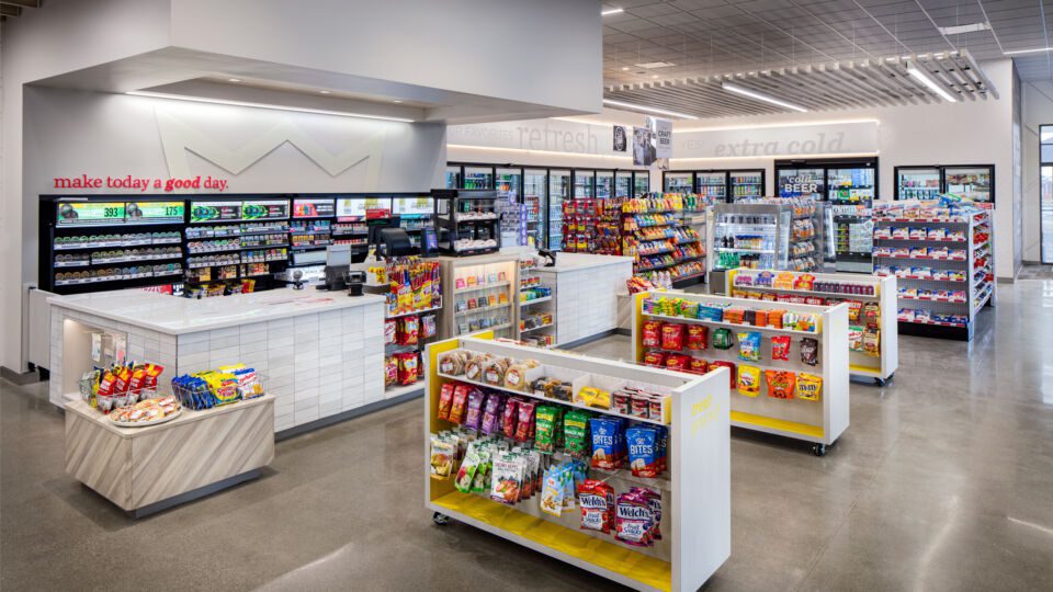 Stacked white gloss tile and wood tones add a modern touch and a neutral backdrop to all the merchandise on display. Low merchandisers anchored to the corners allow for additional story opportunities.