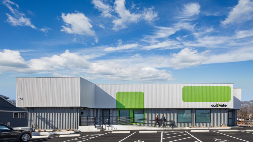 The exterior treatment to the adapted building shows two types of metal paneling and graphics to help identify the destination.