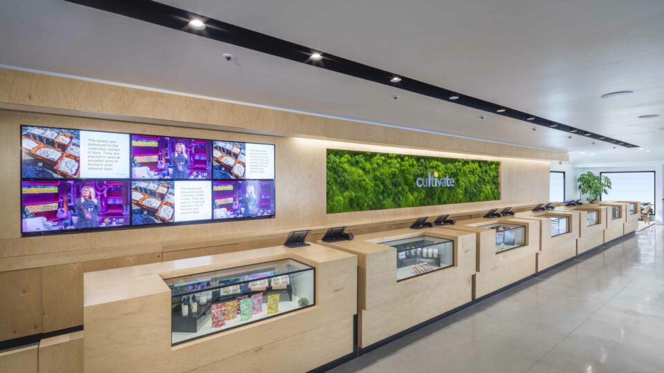 The client services area incorporates digital displays to share product updates and news.