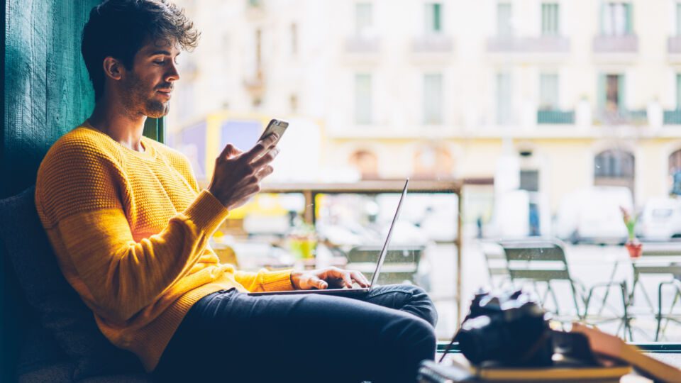 A young man using his smartphone to shop online