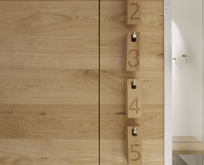 The material palette includes light oak, concrete, and mirrors - resulting in a fresh interior space that feels expansive and urban.