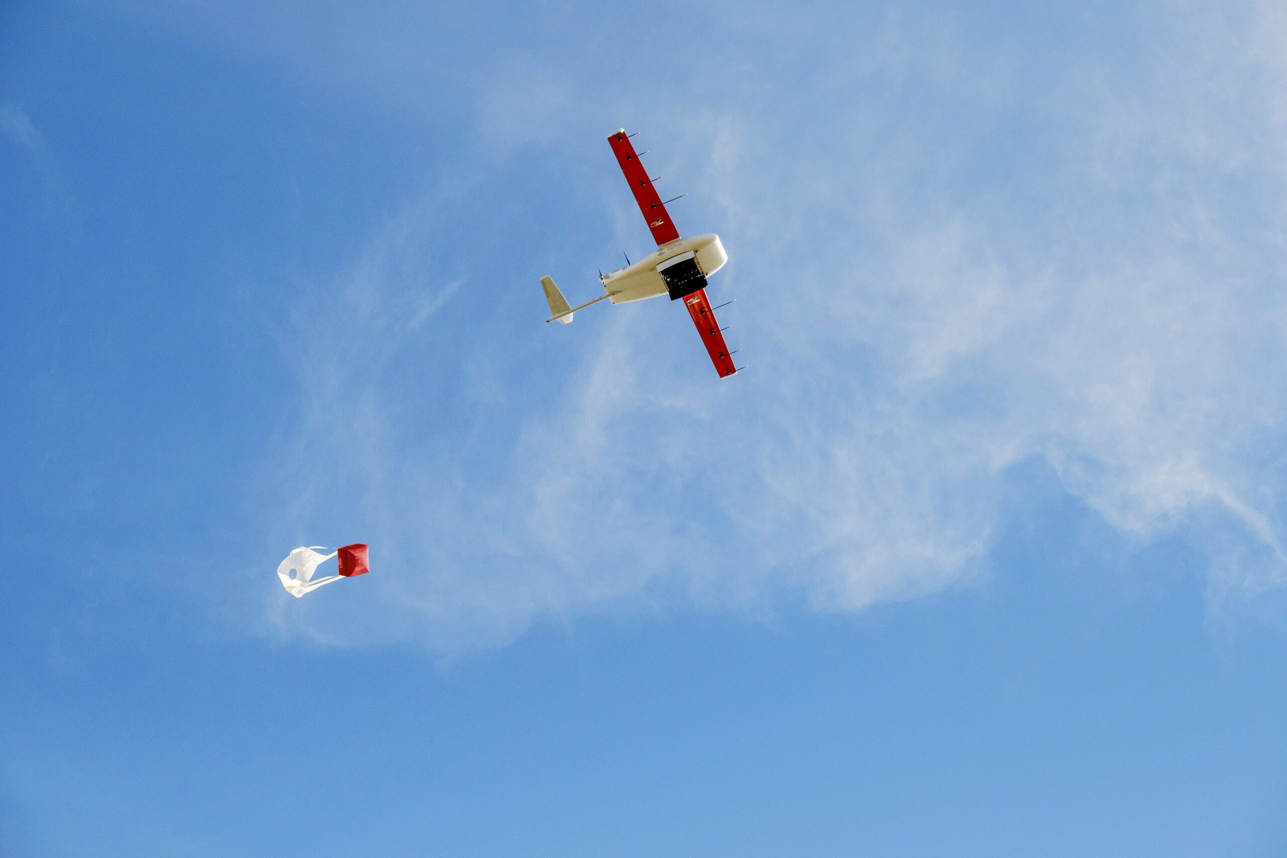 A Zipline drone drops a package for delivery.