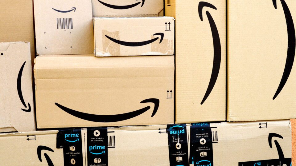 Wall of Amazon packaging with the familiar "smile" icon.