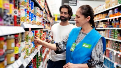 Shopper and associate in a Walmart store.