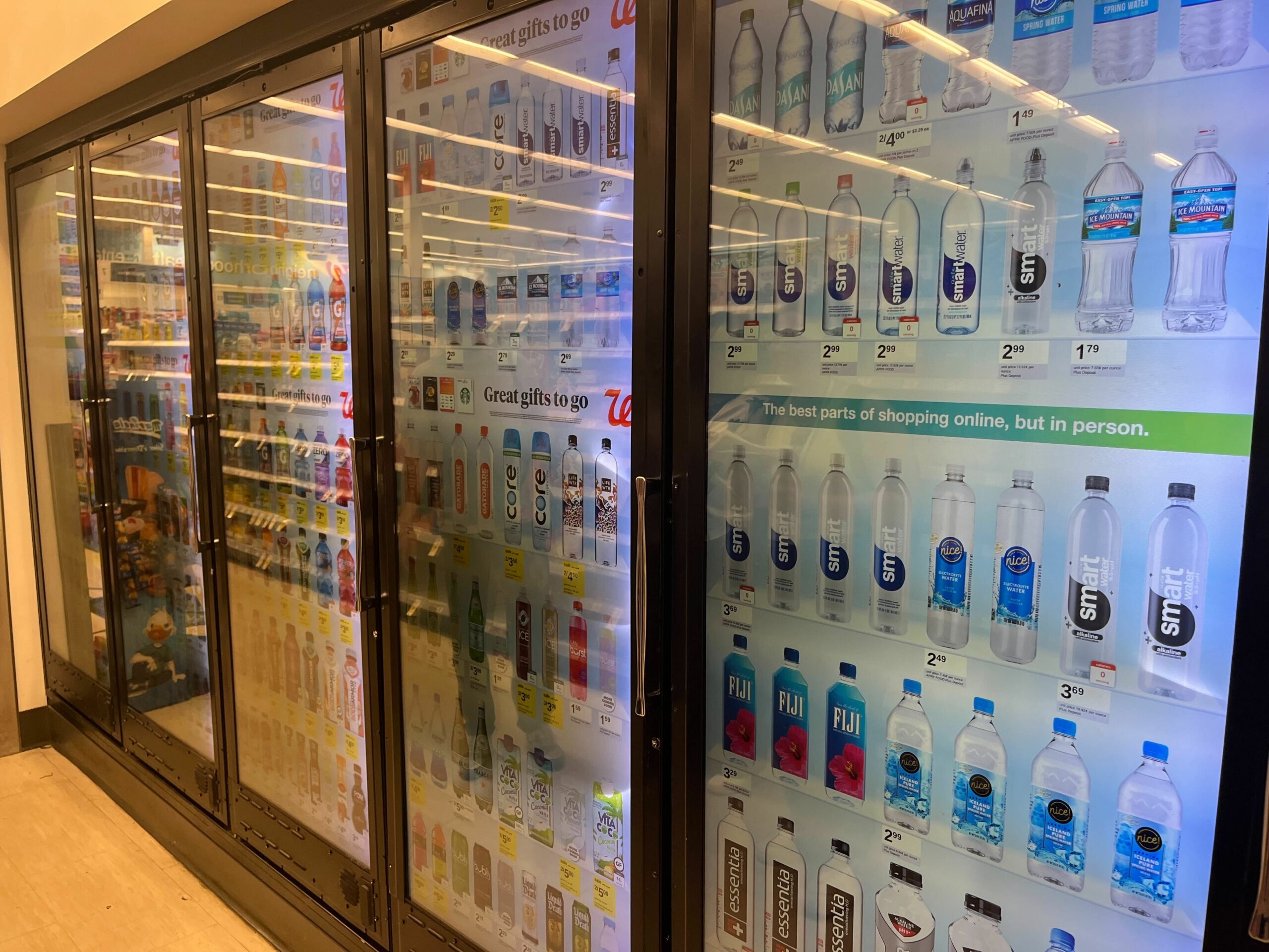 Cooler doors with screens at a Walgreens.