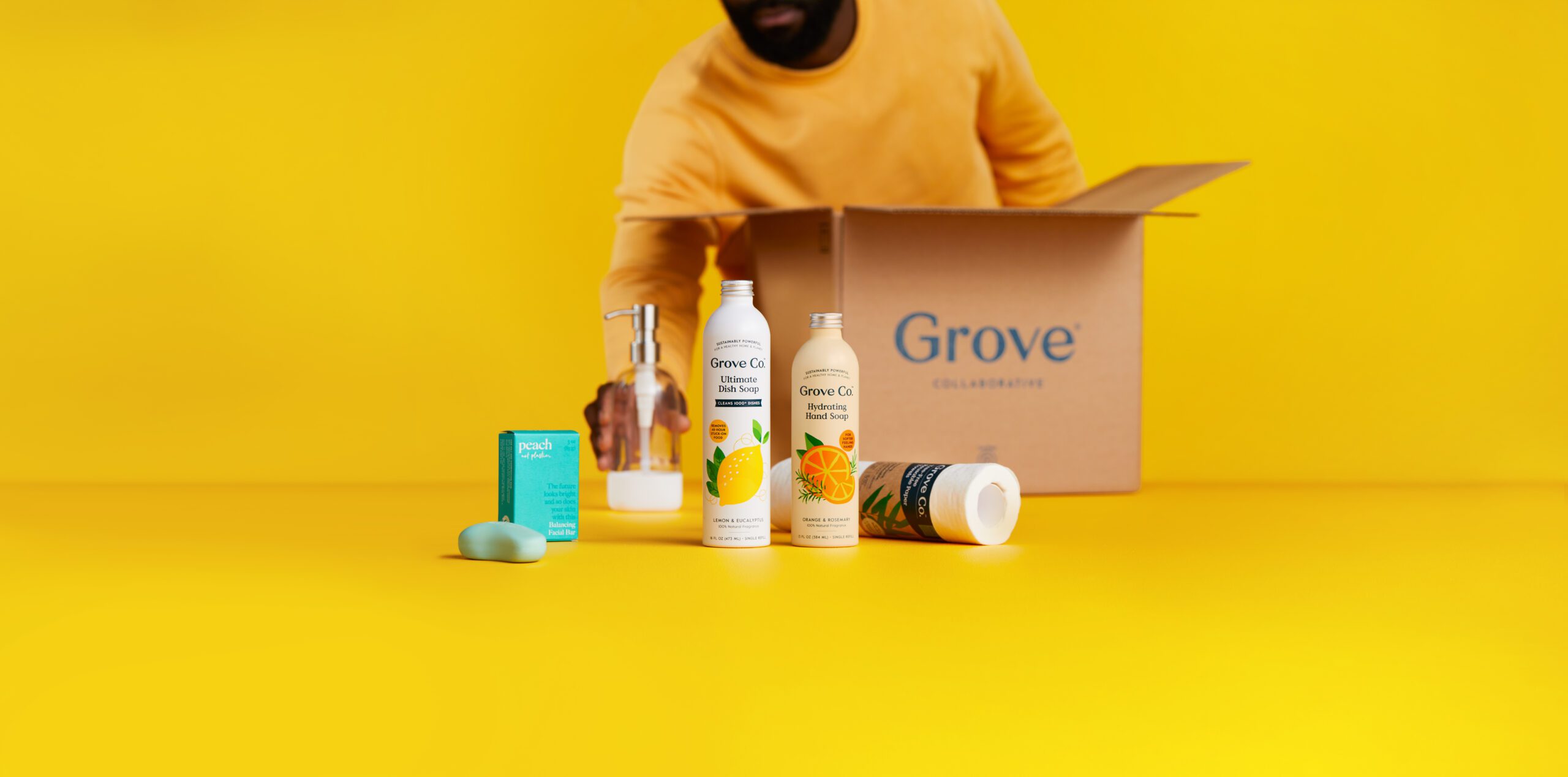 Man unpacks box from Grove Collaborative.