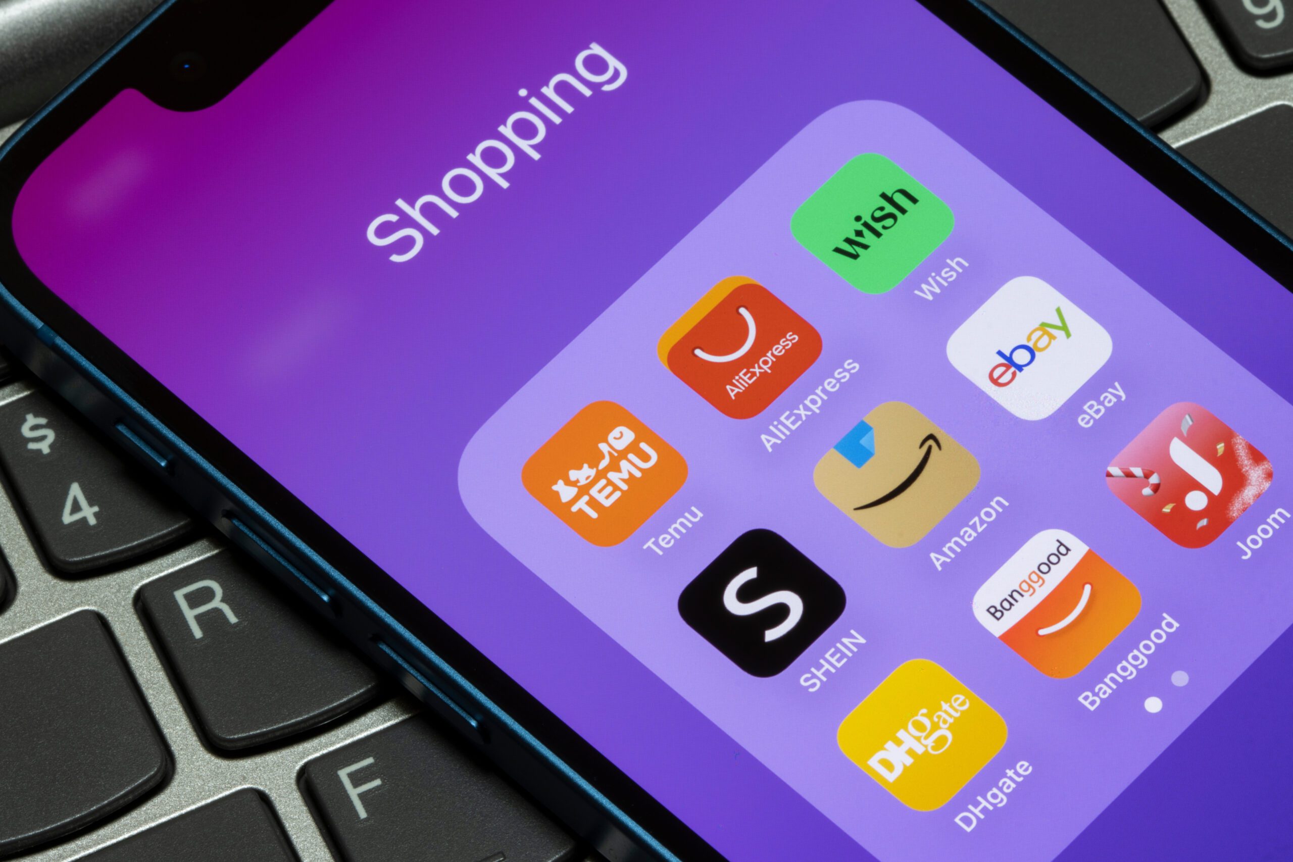 Phone home screen with shopping apps including Shein and Temu
