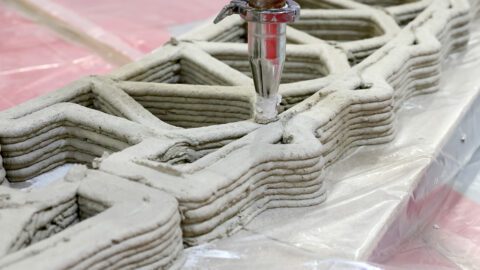 3D concrete printing is used to make a building wall.