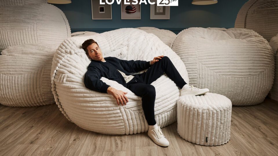 Olympic snowboarder Shaun White chills in the modern version of Lovesac's original beanbag chair.