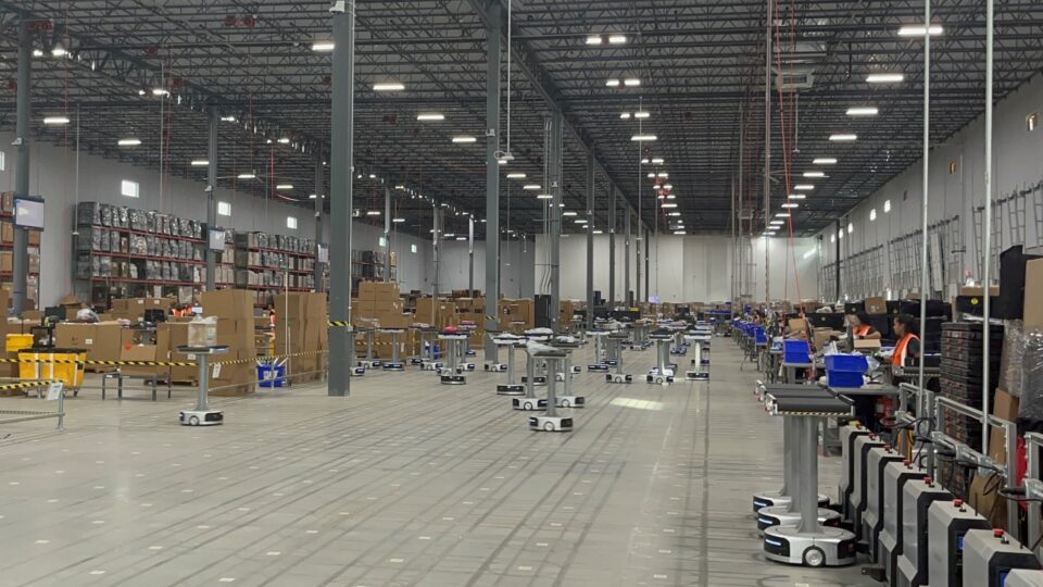 180 "Dancing Robots" work alongside humans at a Happy Returns' Hub to process millions of returns each month.