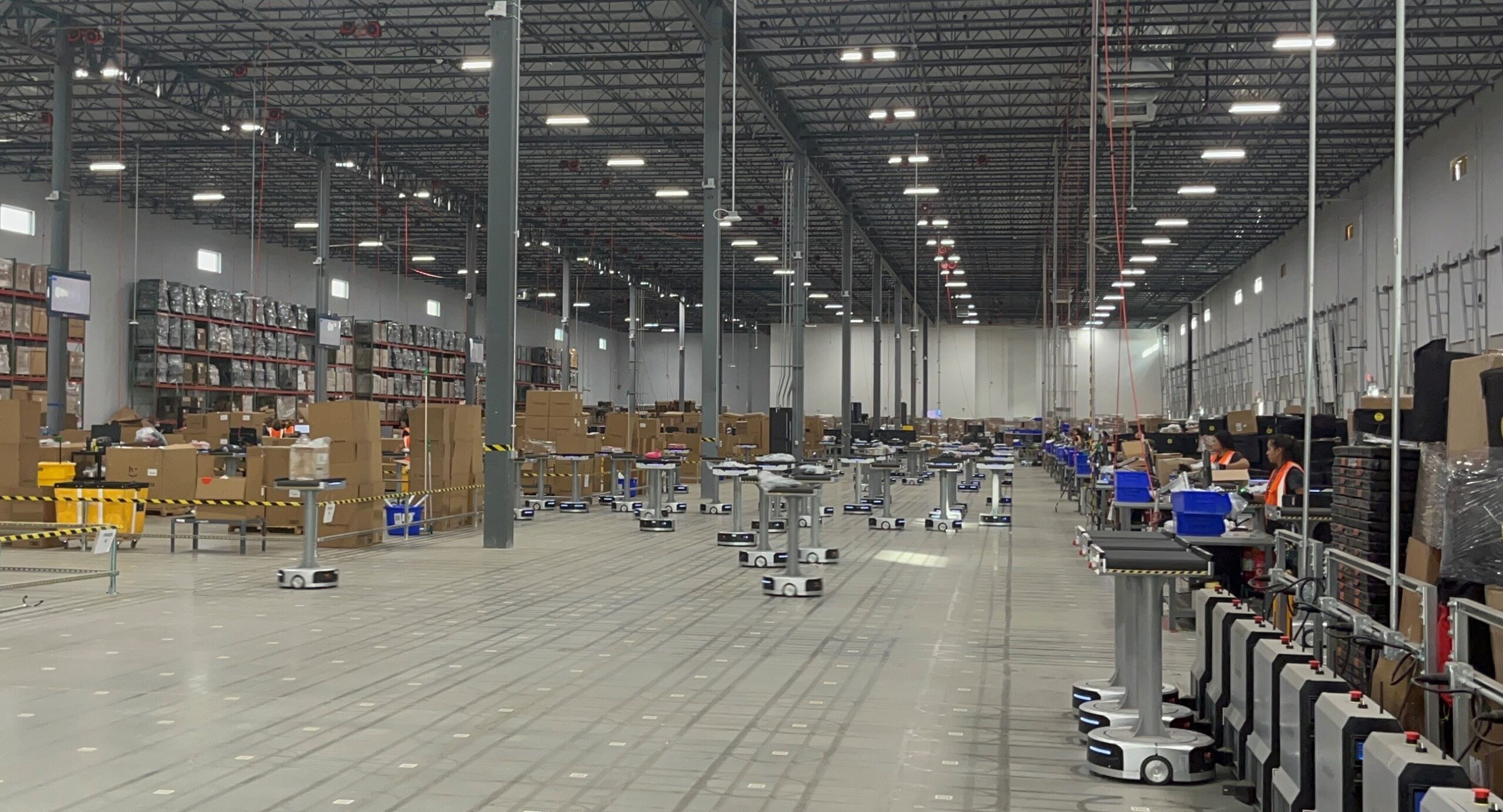 180 "Dancing Robots" work alongside humans at a Happy Returns' Hub to process millions of returns each month.