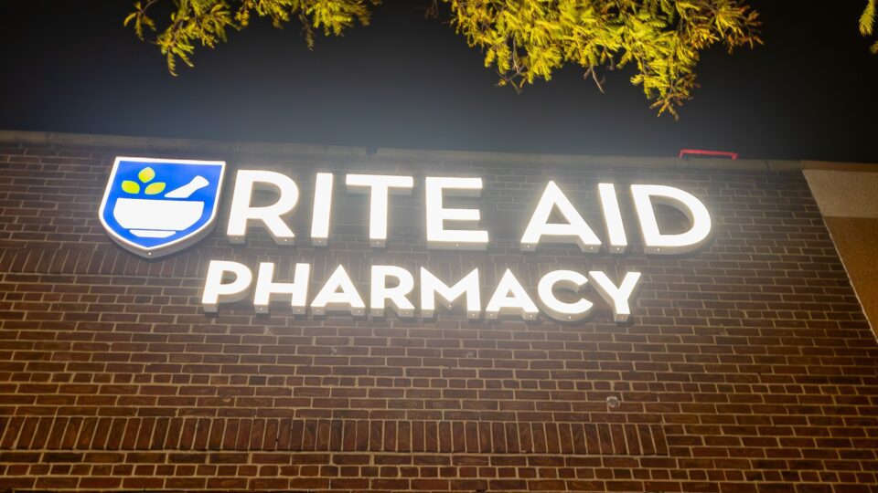Rite Aid logo on a storefront. Rite Aid IP is now for sale.