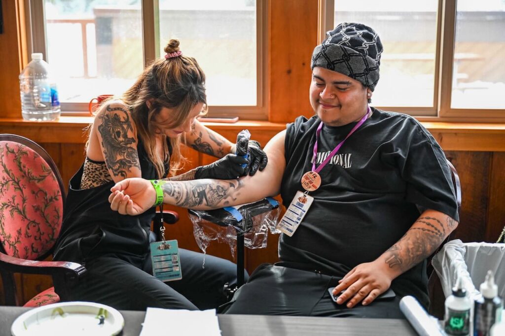 The brand Lurking Class brought a tattoo artist to the 100k celebration.