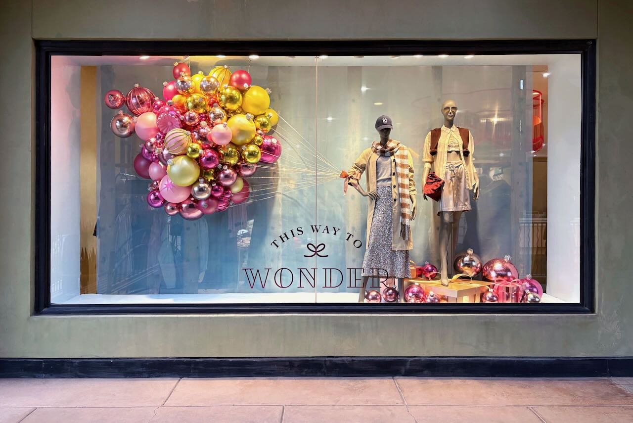 A holiday window in 2025 featured ornaments that floated through the air like festive balloons. Photo courtesy of Anthropologie.